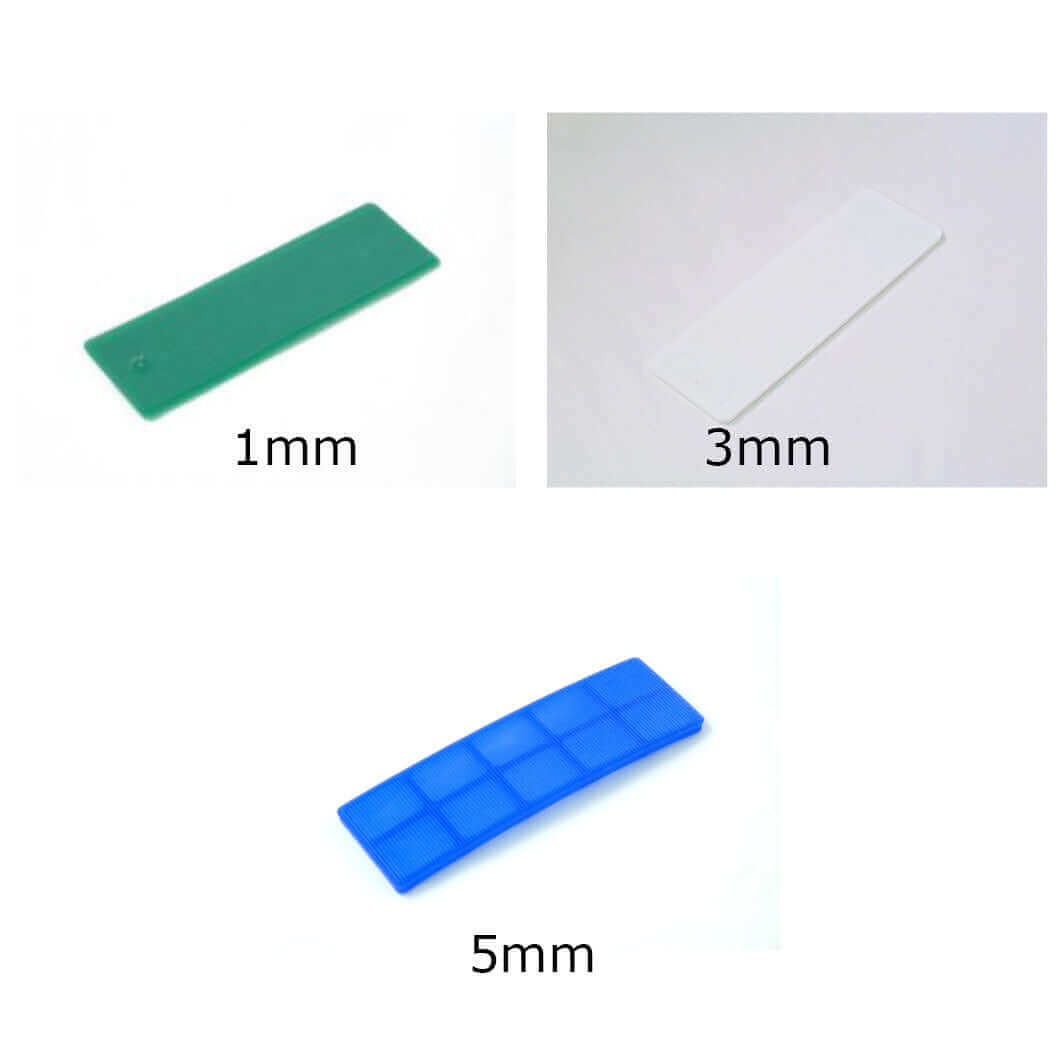 Glazpart glazing packers in 1mm, 3mm, and 5mm sizes, shown in green, white, and blue, for versatile spacing solutions.